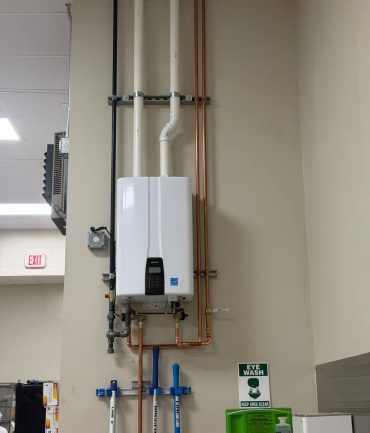 Navien tankless water heater with copper piping installed by AFAB Construction