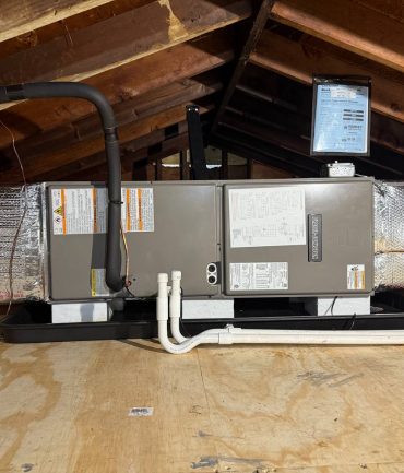 Attic air handler on a drain pan with mounted control panel installed by AFAB Construction