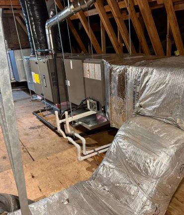 Attic air handler with insulated ductwork and copper lineset installed by AFAB Construction