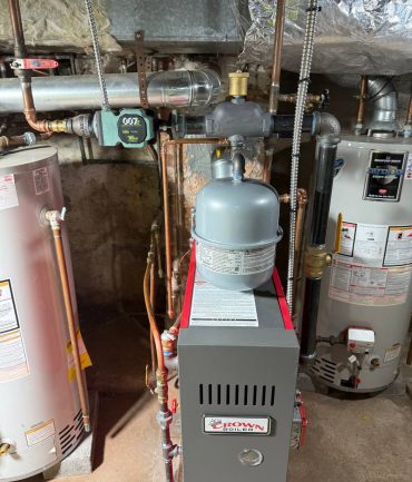 Crown gas boiler with expansion tank and water heaters installed in a basement by AFAB Construction in West Milford NJ