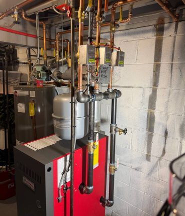 Gas boiler with multiple heating zones and copper piping installed by AFAB Construction