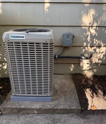 Guardian outdoor AC condenser unit with disconnect box installed on a concrete pad by AFAB Construction in West Milford NJ