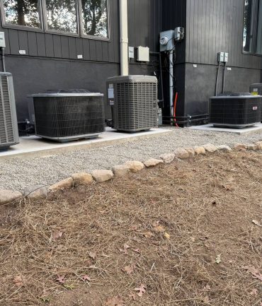 Row of five outdoor AC condenser units installed on a concrete pad by AFAB Construction in West Milford NJ